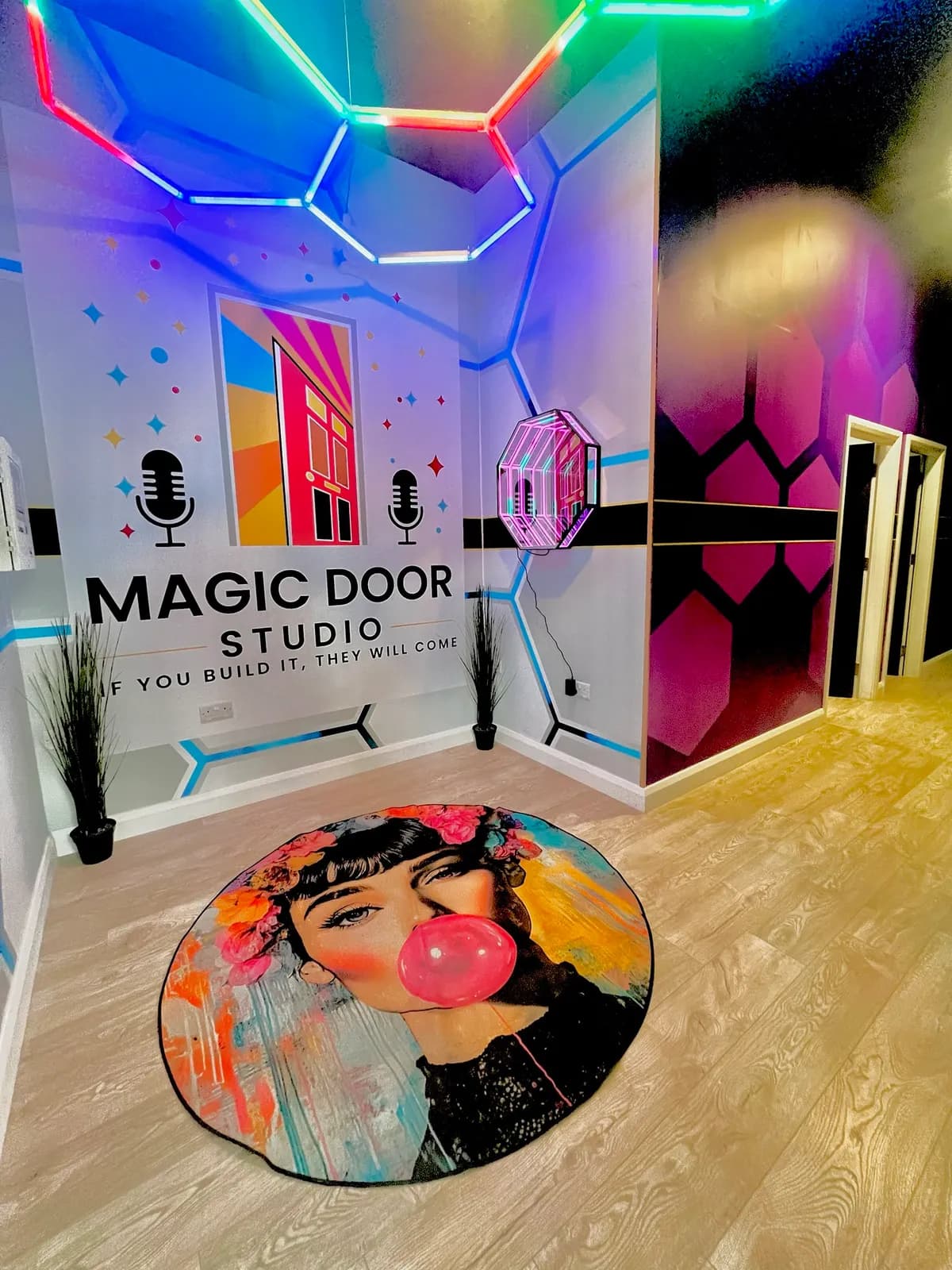 The Magic Door Studio entrance: rainbow hexagon LEDs, logo mural and pop-art rug