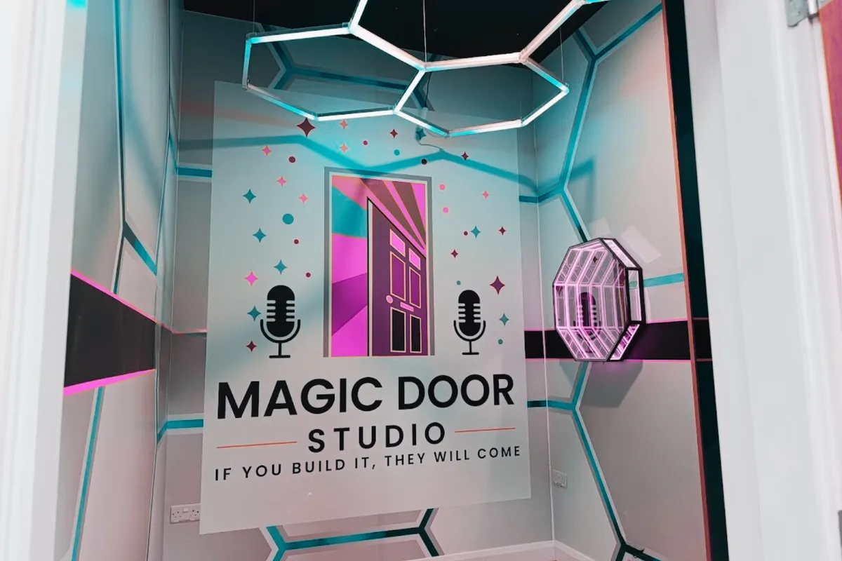 The Magic Door entrance in teal and pink neon