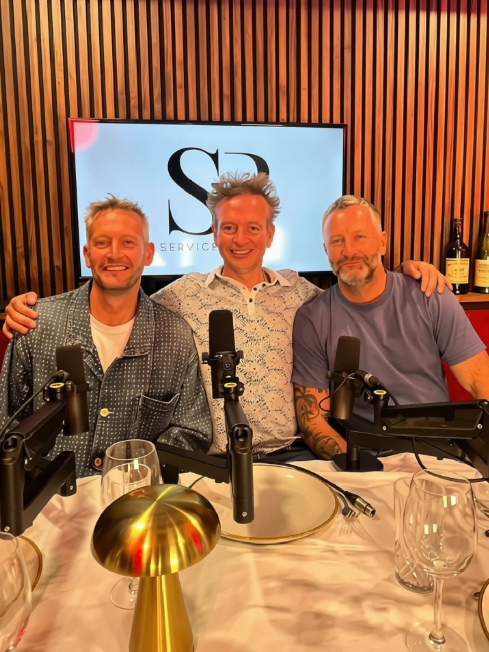 Charly Egan and guests in front of the Service Please logo at Magic Door Studio