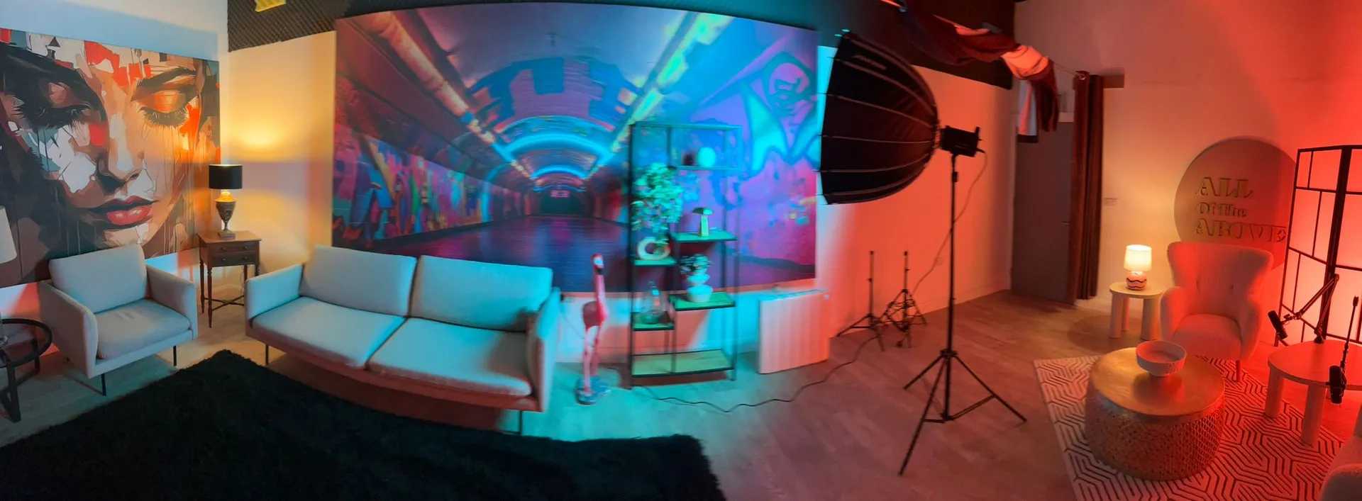 Panoramic sweep of Studio 2: face mural, neon tunnel and pink arch zones