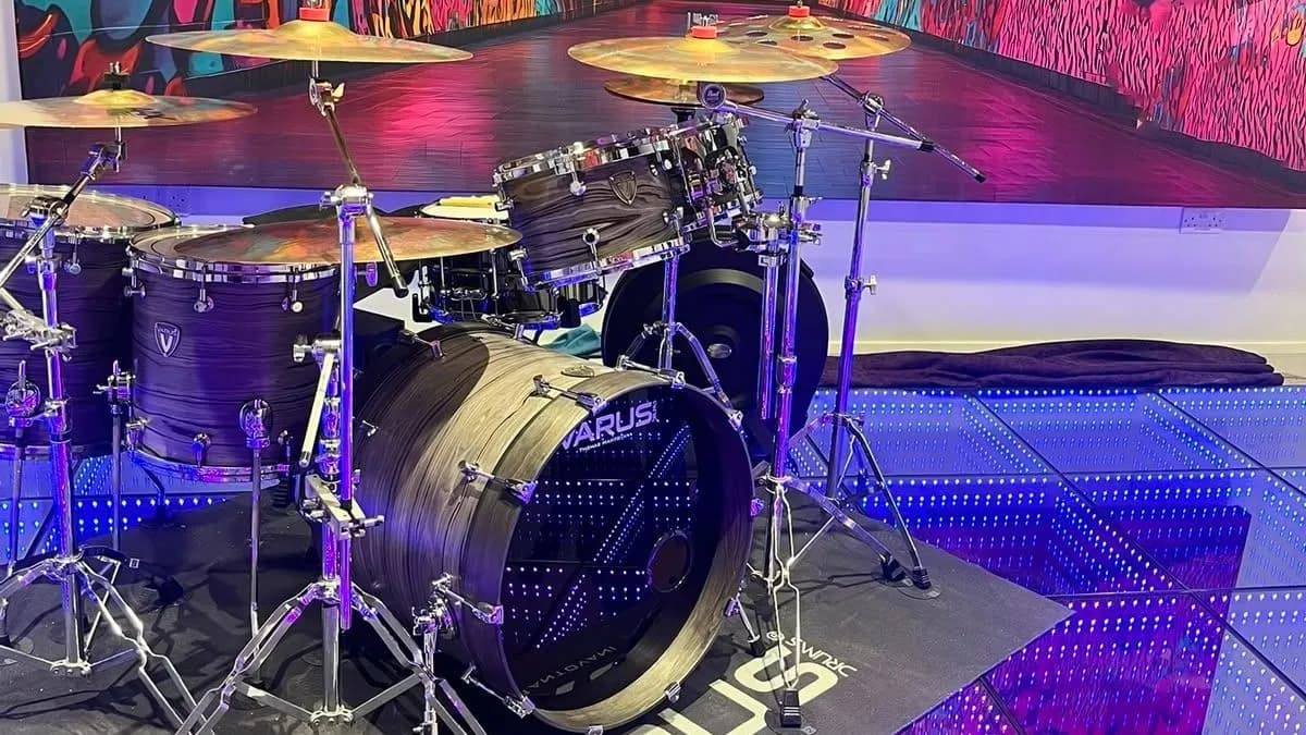 A full drum kit set up on the infinity LED floor in front of the graffiti tunnel